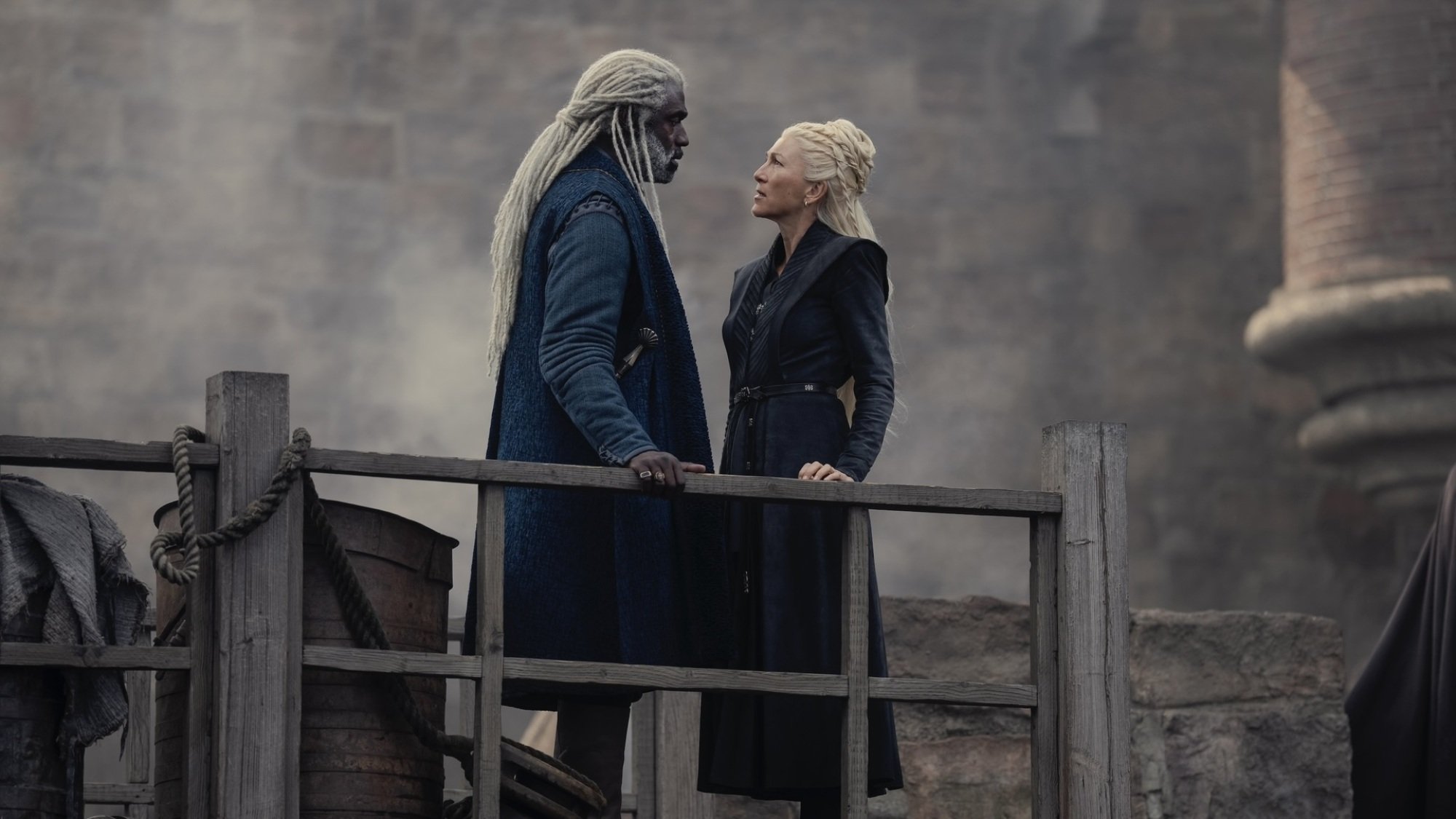 Corlys Velaryon and Rhaenys Targaryen have a discussion in a shipyard.