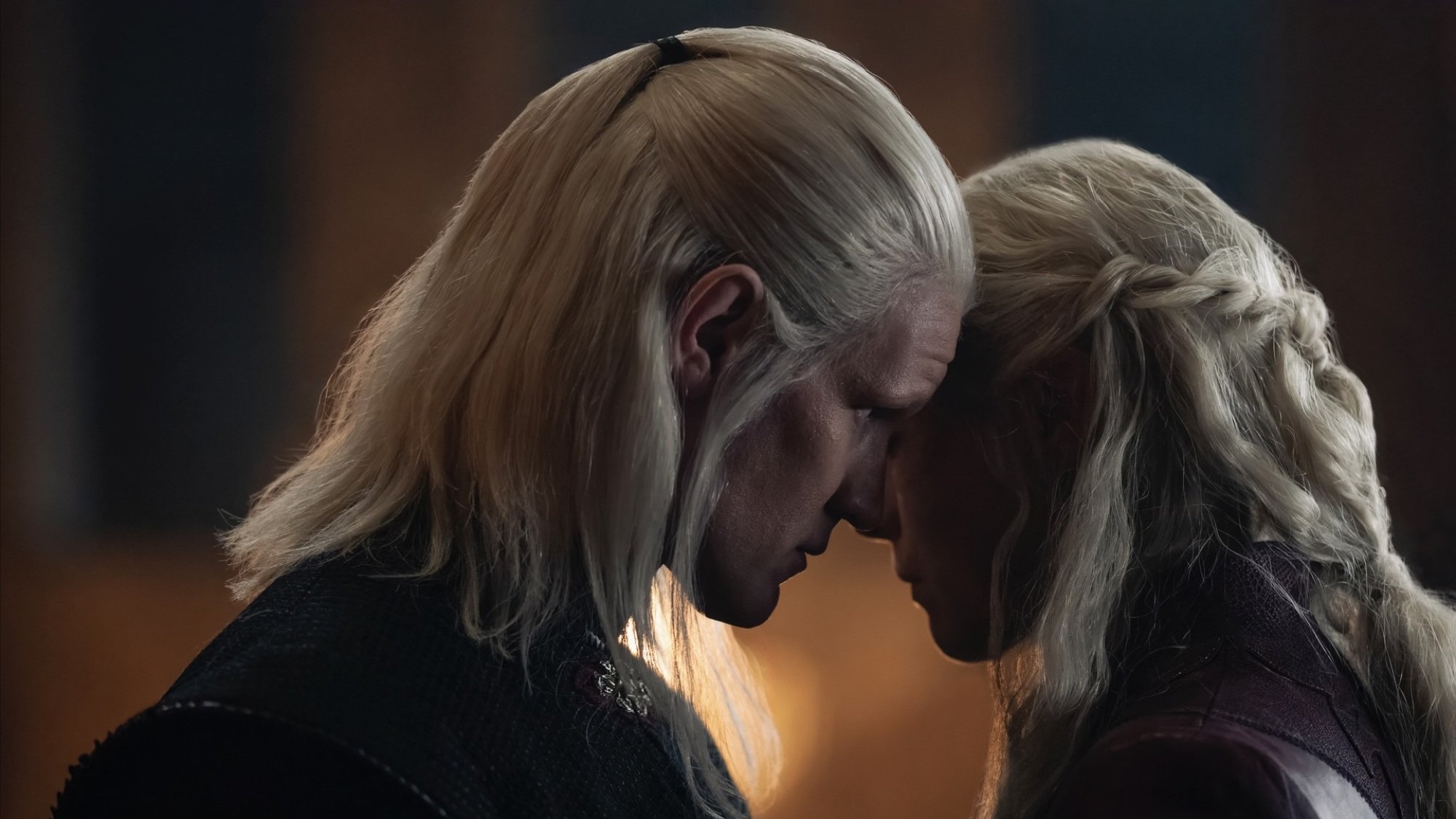 Daemon and Rhaenyra Targaryen speak with their faces very close together.