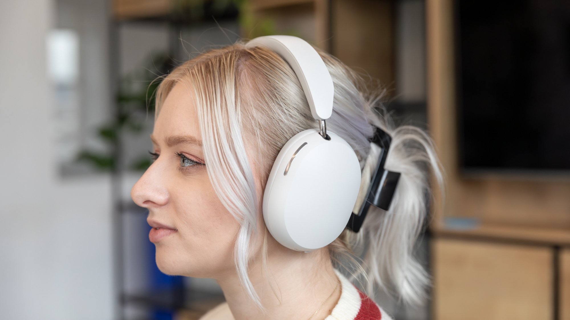 woman wearing white sonos ace headphones