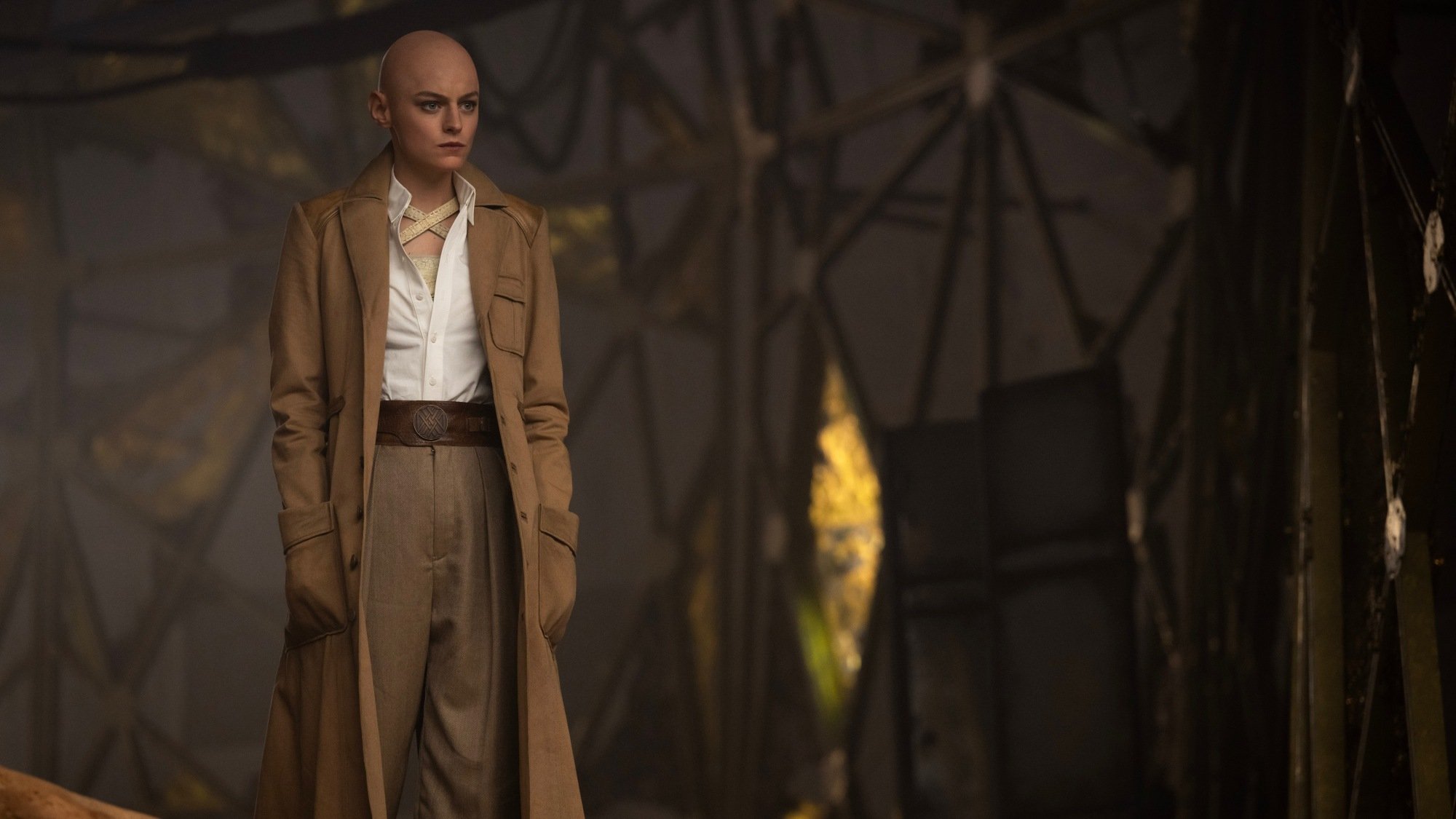 Cassandra Nova in a trench coat, standing in her lair.