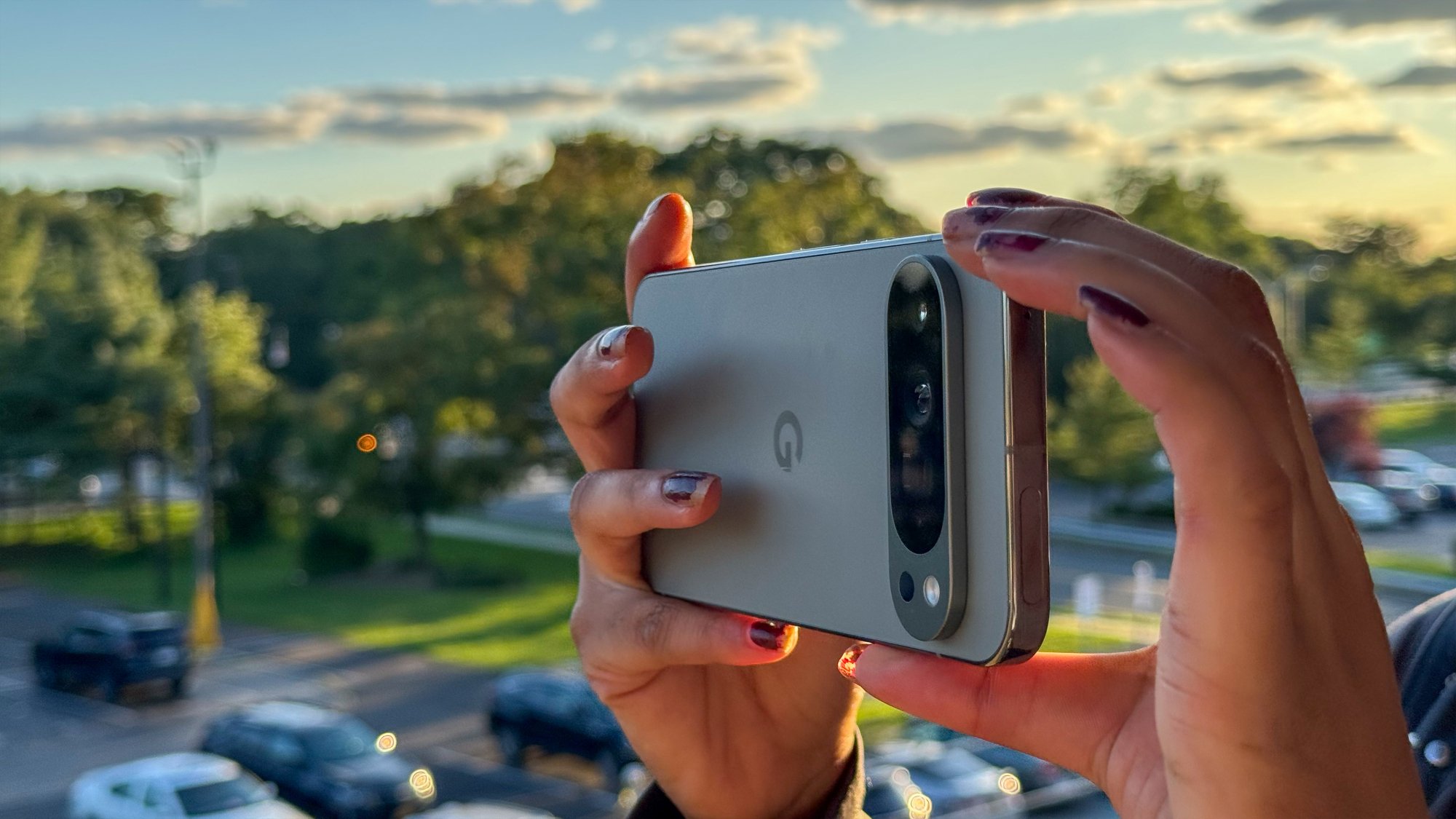 The Pixel 9 Pro XL being held horizonally as someone appears to take a photograph.