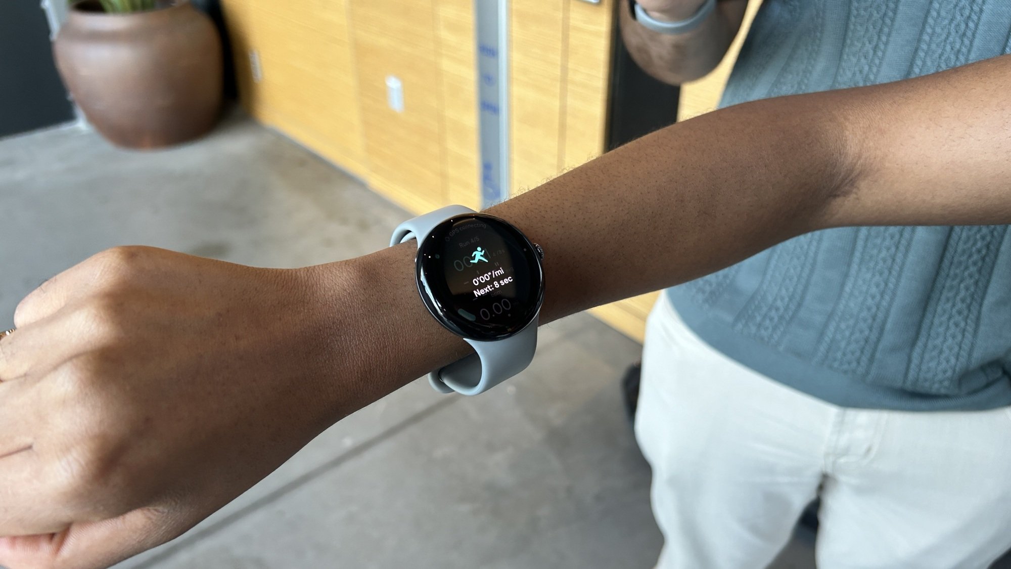 the pixel watch 3 on a wrist showing a running app