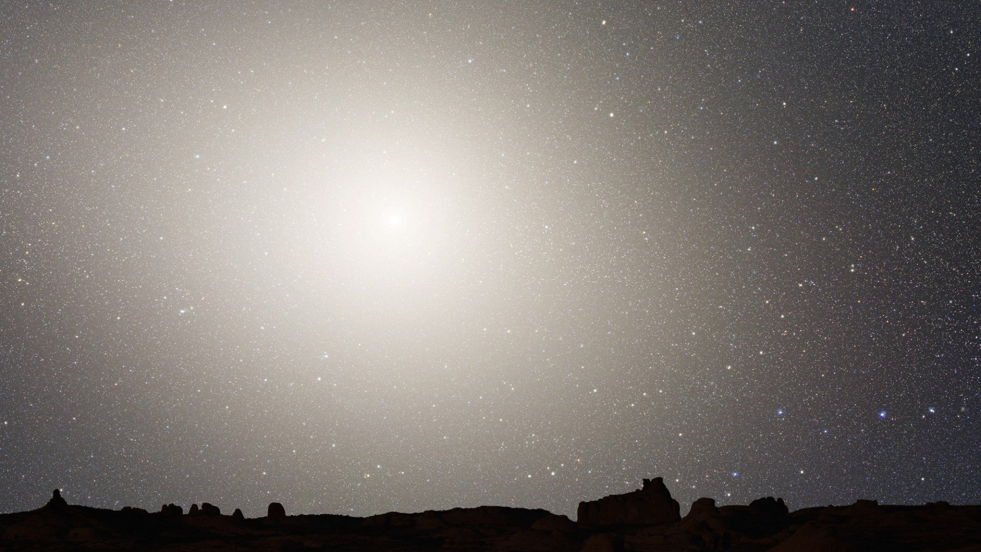 A giant elliptical galaxy formed after the merger of the Milky Way and Andromeda, as hypothetically seen from Earth.