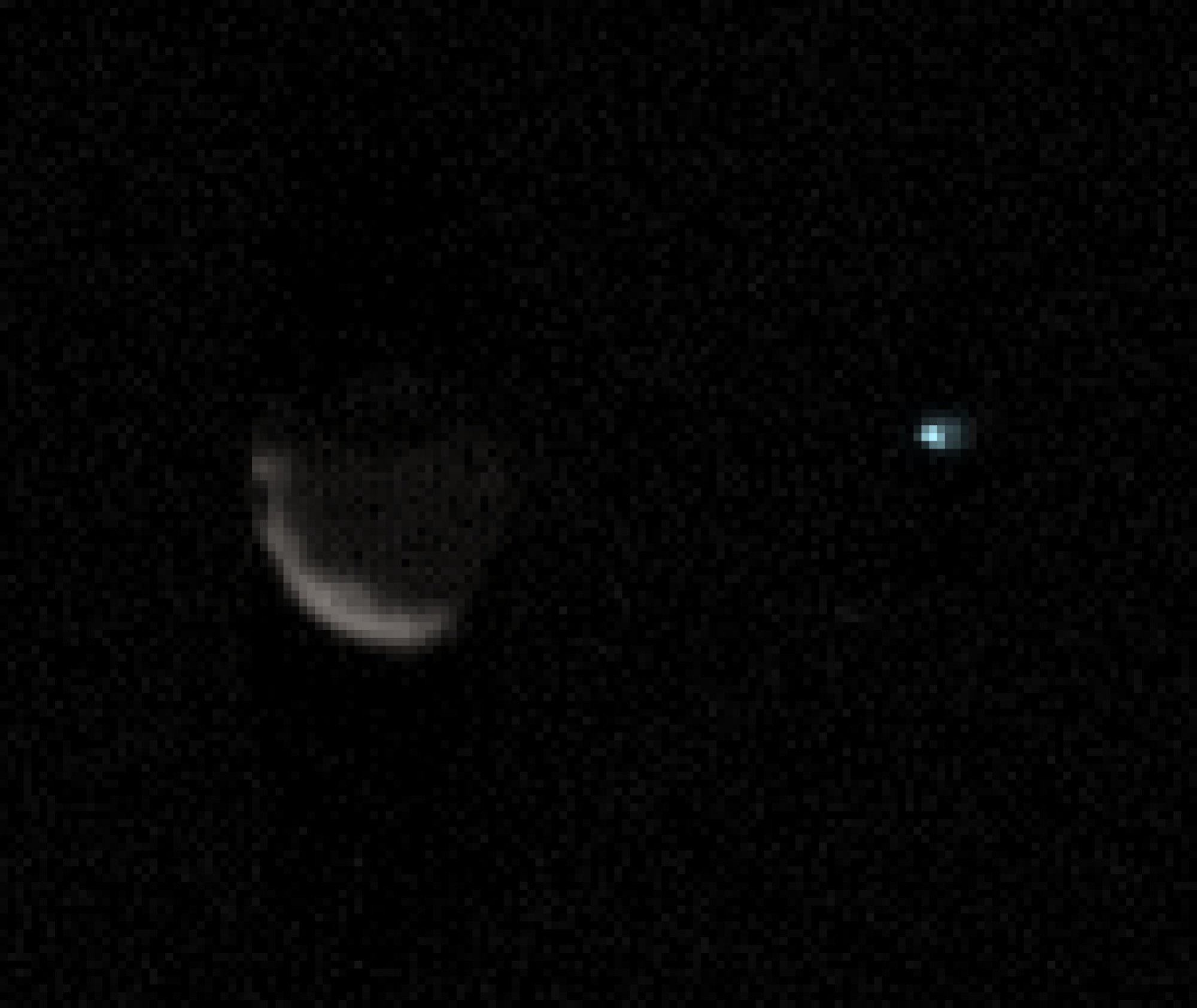 A zoomed-in view of Phobos, on left, and Earth. 