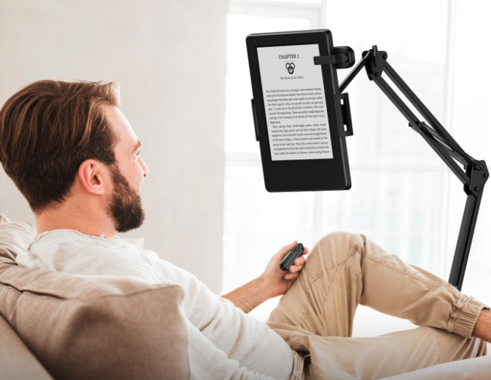 man reading on kindle with remote