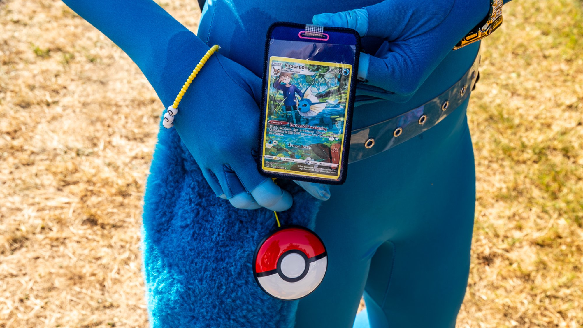 A woman in blue shows off her Pokémon GO accessories.