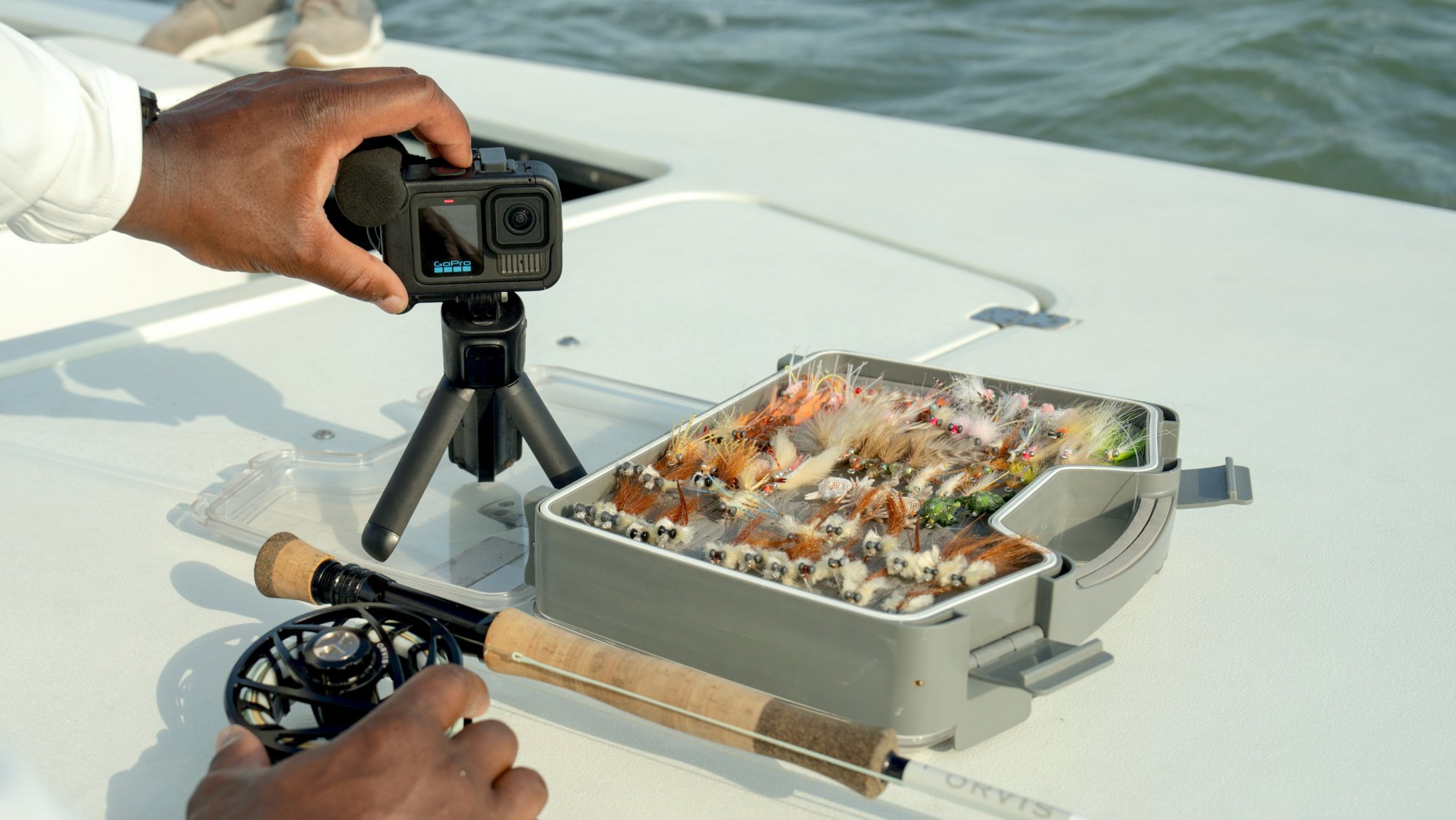 fisherman using gopro hero13 black on a boat with reel and fishing tackle