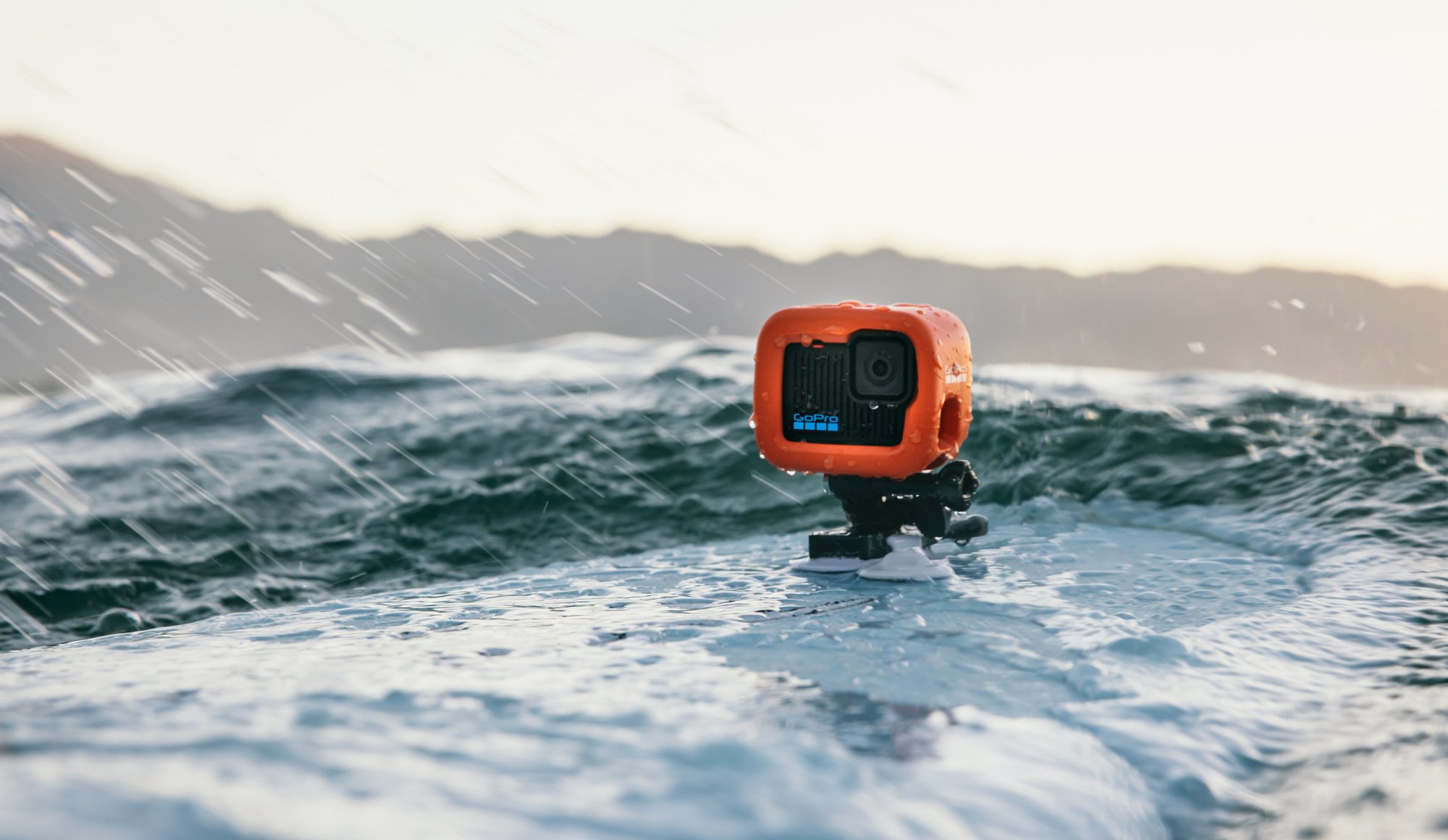 gopro hero action camera on a surfboard in ocean